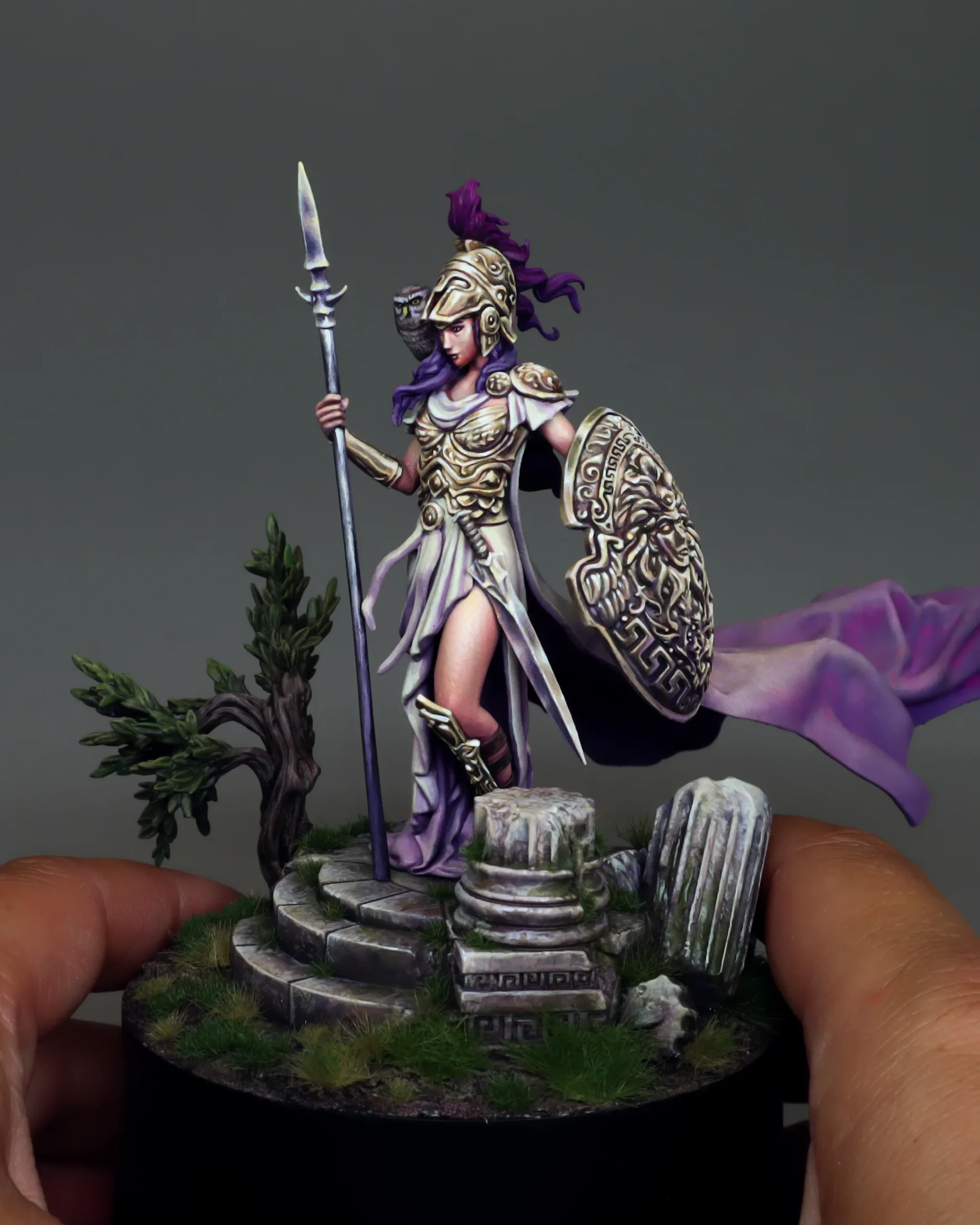 Athena 75mm resin miniature held in hands to show actual scale