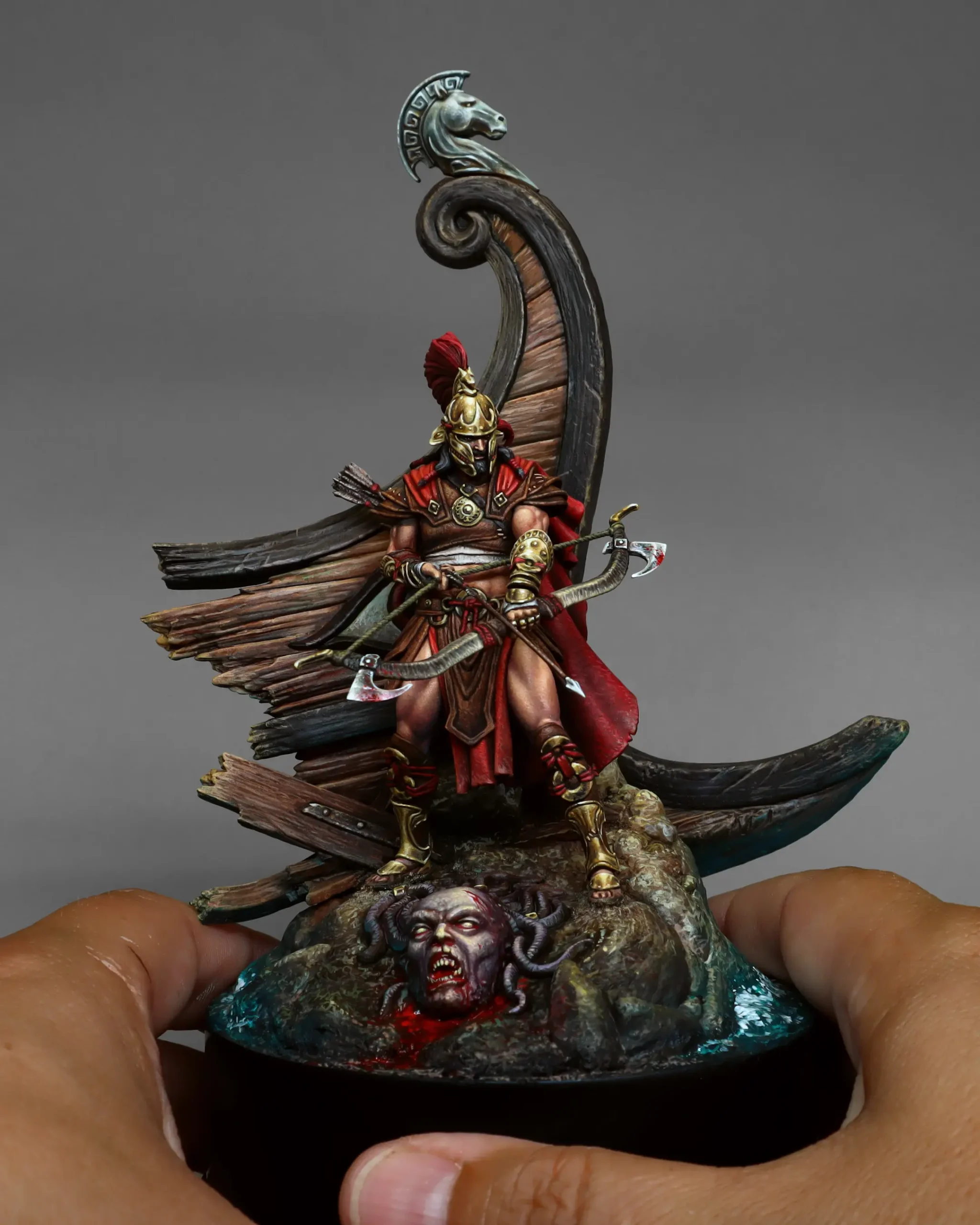 Odysseus 75mm resin miniature held in two hands as a size reference